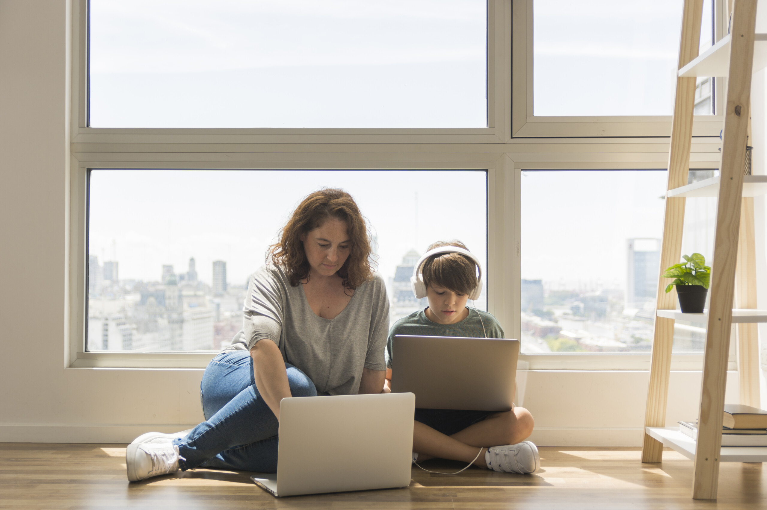 young-boy-playing-laptop-mom